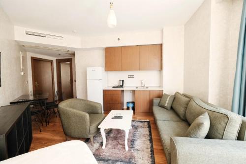 a living room with a couch and a table at SABİHA GOKCEN İSTANBUL HOUSES Airport in Istanbul