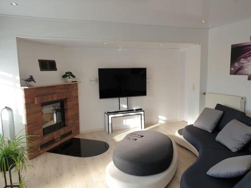 a living room with a couch and a fireplace at Ferienwohnung im modernen Ambiente mit eigenem Außenbereich in Waldeck