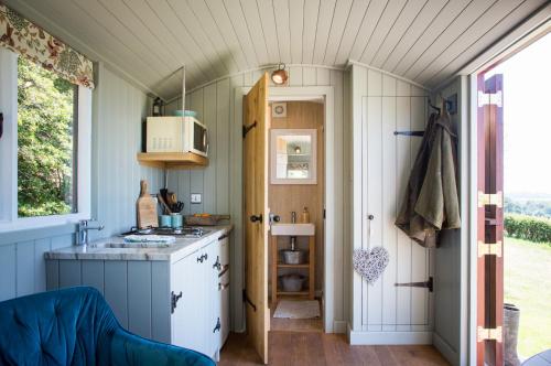 a kitchen with a sink and a stove in a room at Little Idyll shepherds hut in Chester