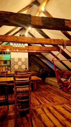 a restaurant with wooden tables and chairs in a room at Butterfly House in Pāvilosta