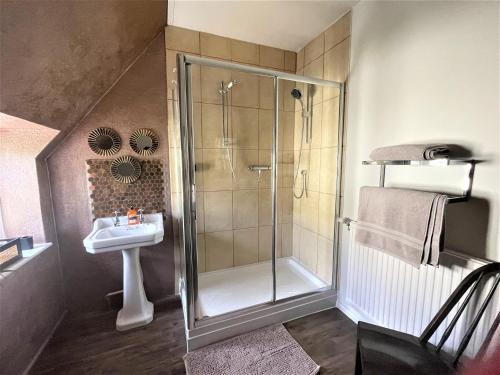 a bathroom with a shower and a sink at The Dairyman Suite in Dorchester