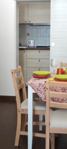 a kitchen with a table with two chairs and a table with plates at Lithos house pt 1p e 2p in Monopoli