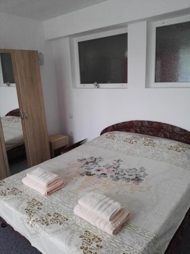 a bedroom with a bed with two towels on it at Вила Полина in Varna City