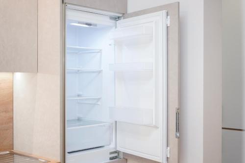 a refrigerator with its door open in a kitchen at ROGA Apartment Valamar in Hamallë