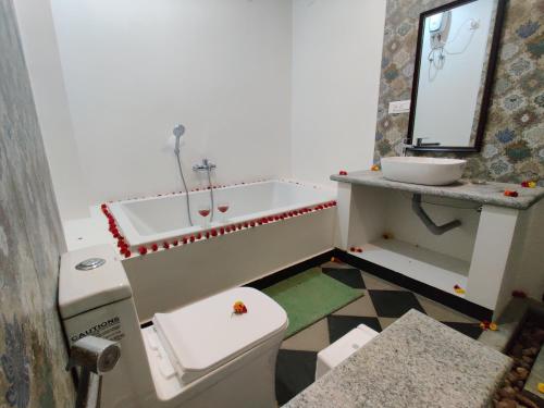 a bathroom with a sink and a toilet at The Balified Villa in Puducherry