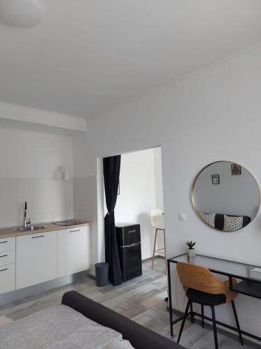 a living room with a table and a mirror at Apartman LUCIJA in Korčula