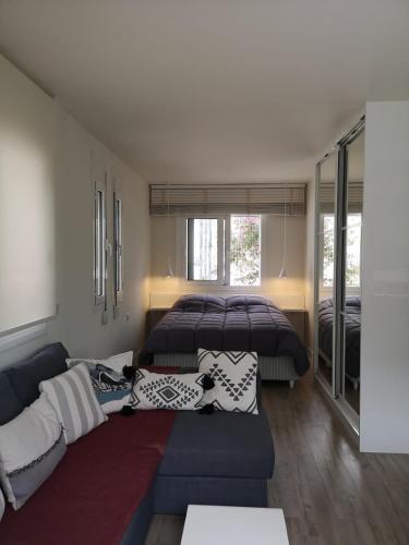 a living room with a couch and a bed at Riviera Studio in Athens