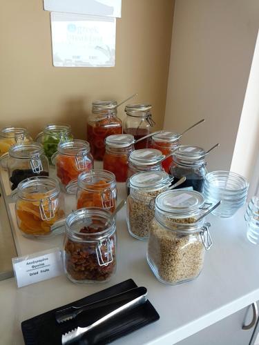 a counter with jars of food on a table at Al Mare Hotel in Tsilivi