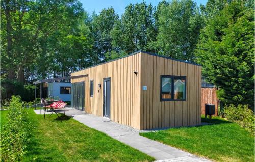 a small wooden building in a yard at Cozy Home In Heinkenszand With Kitchen in Heinkensand