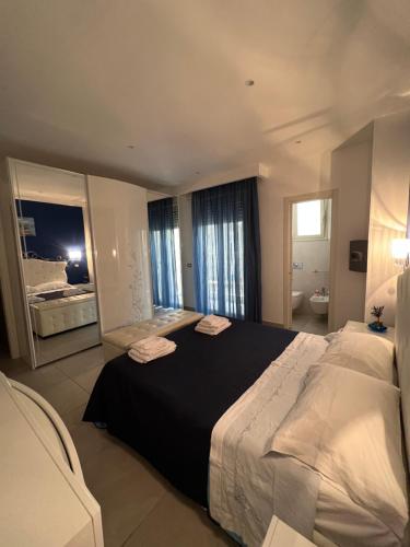 a bedroom with a large bed and a bathroom at Samcri Luxury Home in Catania