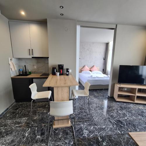 a room with a table and chairs and a bed at Ladadika 5th Floor in Thessaloniki