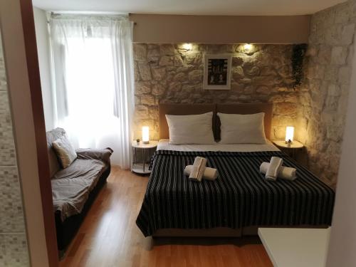 a bedroom with a bed with two candles on it at Carol Rooms in Trogir