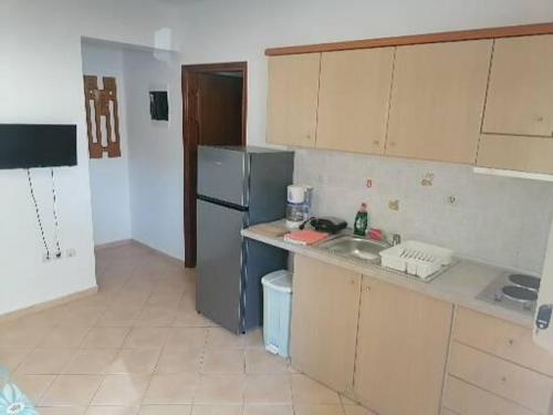 a kitchen with a sink and a refrigerator at Porto Almira Beachfront Apartrments in Nikiti