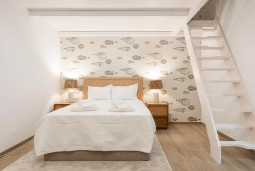 a bedroom with a white bed and a staircase at CATCH - Vilamoura in Vilamoura