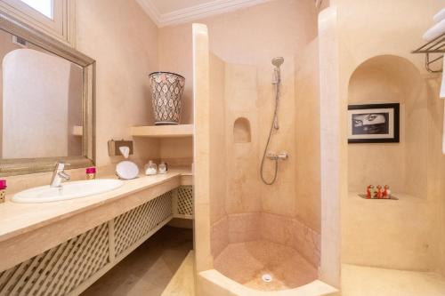 a bathroom with a shower and a sink at Riad Alma in Marrakech