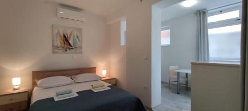 een slaapkamer met een bed met twee handdoeken erop bij Studio apartman Ana in Makarska
