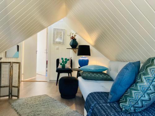 a living room with a couch and a table at Downtown Historical House with Renovated apartments in Ålesund