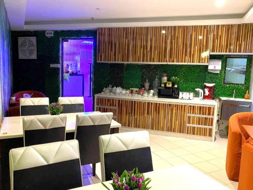 ペタリンジャヤにあるHOTEL SRI SUTRA (BANDAR SUNWAY)の紫のドアとテーブルと椅子が備わるレストラン