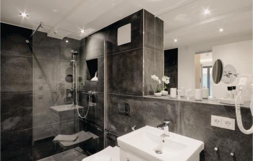 a black and white bathroom with a sink and a shower at Prince in Binz
