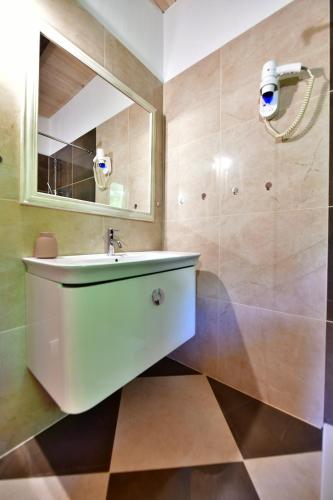 a bathroom with a sink and a mirror at Villa Dobra in Plitvička Jezera