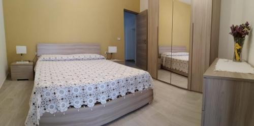 a bedroom with a bed and a large mirror at In Centro - Noto in Noto