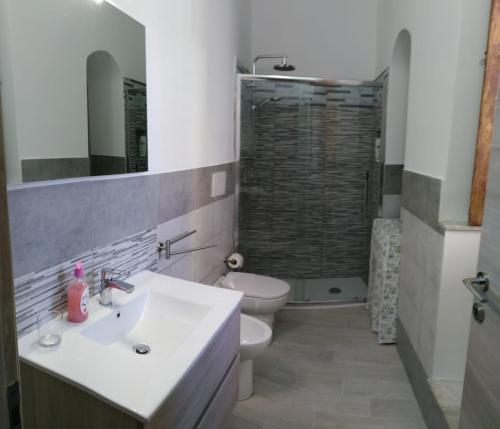 a bathroom with a sink and a toilet and a shower at In Centro - Noto in Noto