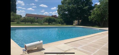 a swimming pool with a white object next to it at Au p’tit bonheur d’augé in Augé