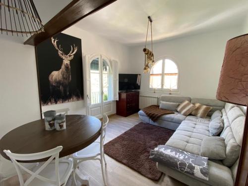 a living room with a table and a couch at Racó del Pirineu in El Pont de Suert