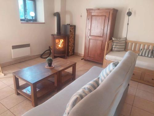 a living room with a couch and a wood stove at Apartmán U Kaštanu in Chvaleč