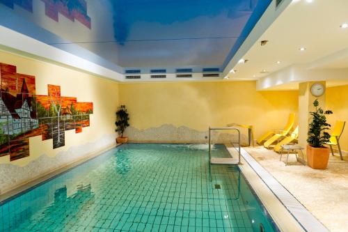 a pool in a hotel room with a swimming pool at Hotel Storck in Bad Laer