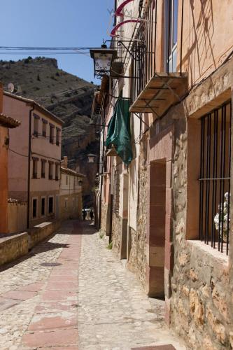 an alley with a flag on the side of a building at Apartamento Blasco in Albarracín