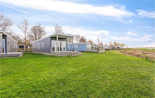 a house in a field with a grass yard at 3 Bedroom Stunning Home In Lauwersoog in Lauwersoog