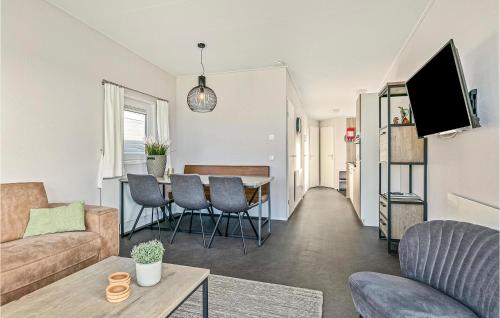 a living room with a couch and a table at 3 Bedroom Stunning Home In Lauwersoog in Lauwersoog