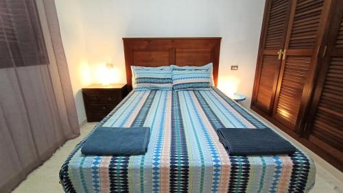 a bed with two pillows on it in a bedroom at alquilaencanarias Tio Claudio Beach in El Médano