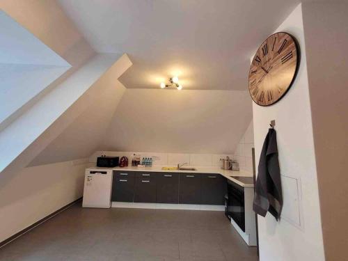 a kitchen with a large clock on the wall at Lovely 2 bedroom apartment Lemon Grass in Central Lindau in Lindau