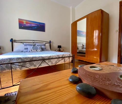 una camera con letto, tavolo e specchio di Montsenigos Garden Apartment a Gouviá