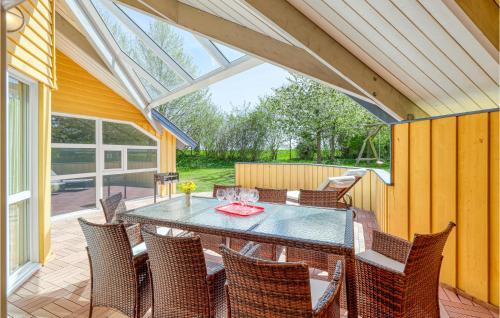 a conservatory with a table and chairs on a patio at Poolhaus 1 In Hohendorf in Hohendorf
