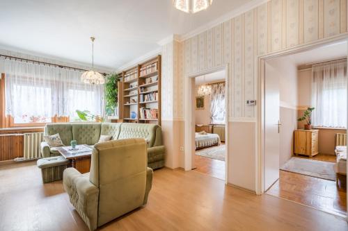 a living room with a couch and a table at Katica Apartment in Balatonszárszó