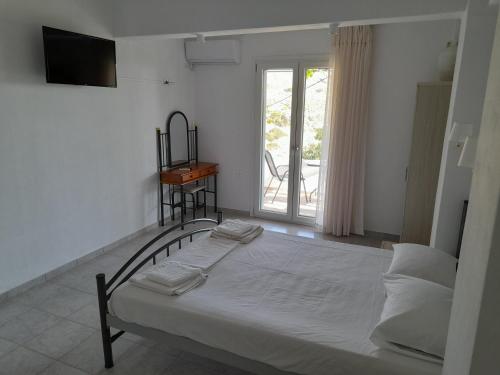 a bedroom with a bed and a window at Silver view in Batsi