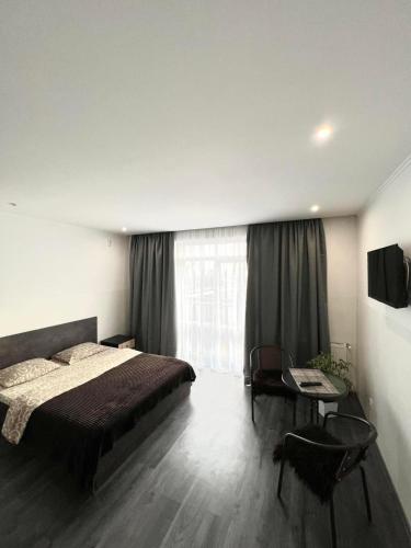 a bedroom with a bed and a large window at Комфортні апартаменти 82 in Ivano-Frankivsk