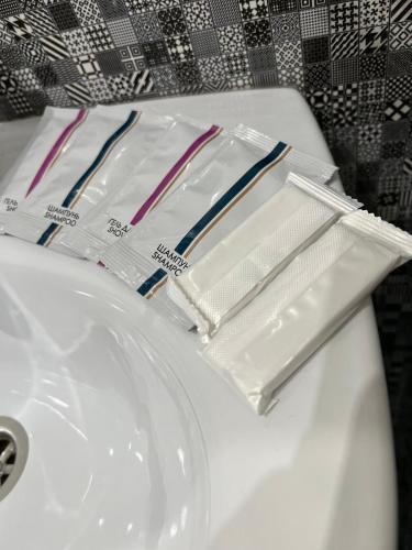 a white sink with toothbrushes and toothpaste on it at Комфортні апартаменти 82 in Ivano-Frankivsk