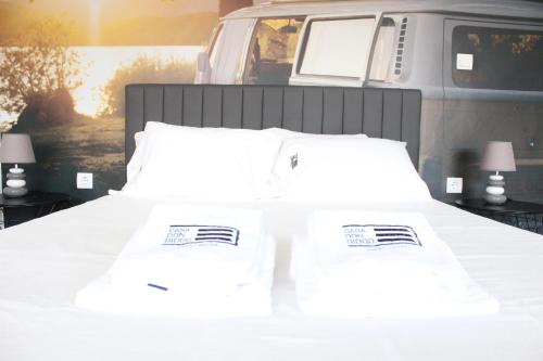 a white bed with two pillows on top of it at Casa Dona Ana in Carviçais