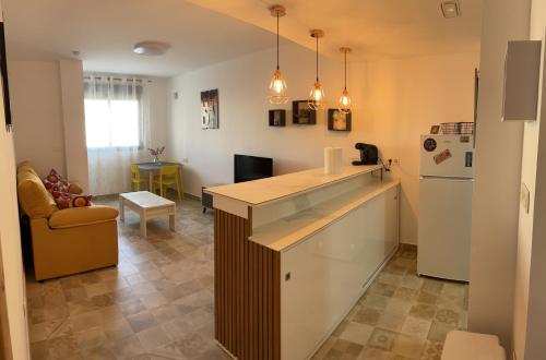 a kitchen with a counter and a refrigerator at Apartamento El Azul in Molina de Segura