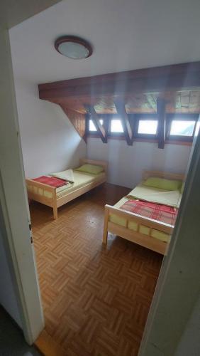 a room with two bunk beds in a room at Tičarjev Dom at Vrsic pass in Soča