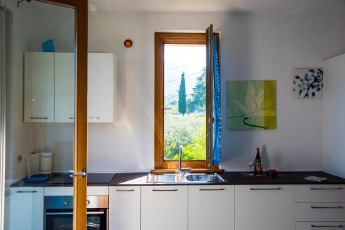 a kitchen with a sink and a window at Italian Vacation Homes - Longol in Riva di Solto
