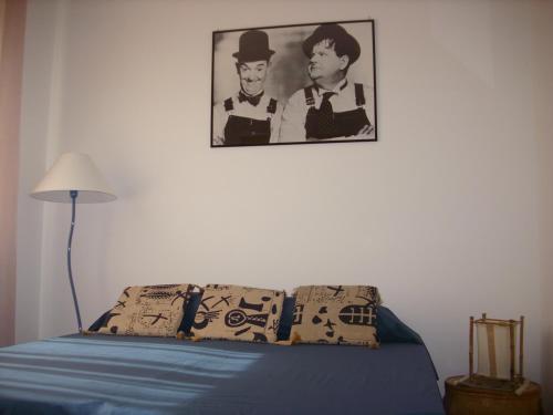 a bedroom with a bed with a picture on the wall at Maria del Mar in Monopoli