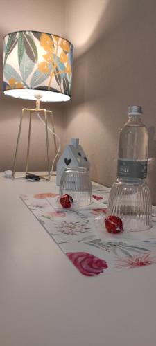 a bottle of water on a table with a lamp at B&B Cascina Grattinera in Sale San Giovanni
