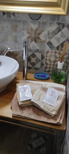a bathroom counter with two towels and a sink at B&B Cascina Grattinera in Sale San Giovanni