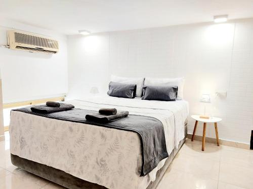 Un dormitorio con una cama grande con toallas. en Estudios GLORIA, en Alicante
