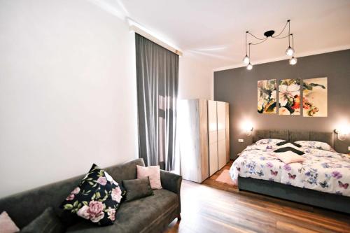 a living room with a bed and a couch at Apartment Carissima-Direct on sea, Lovran-Opatija in Lovran